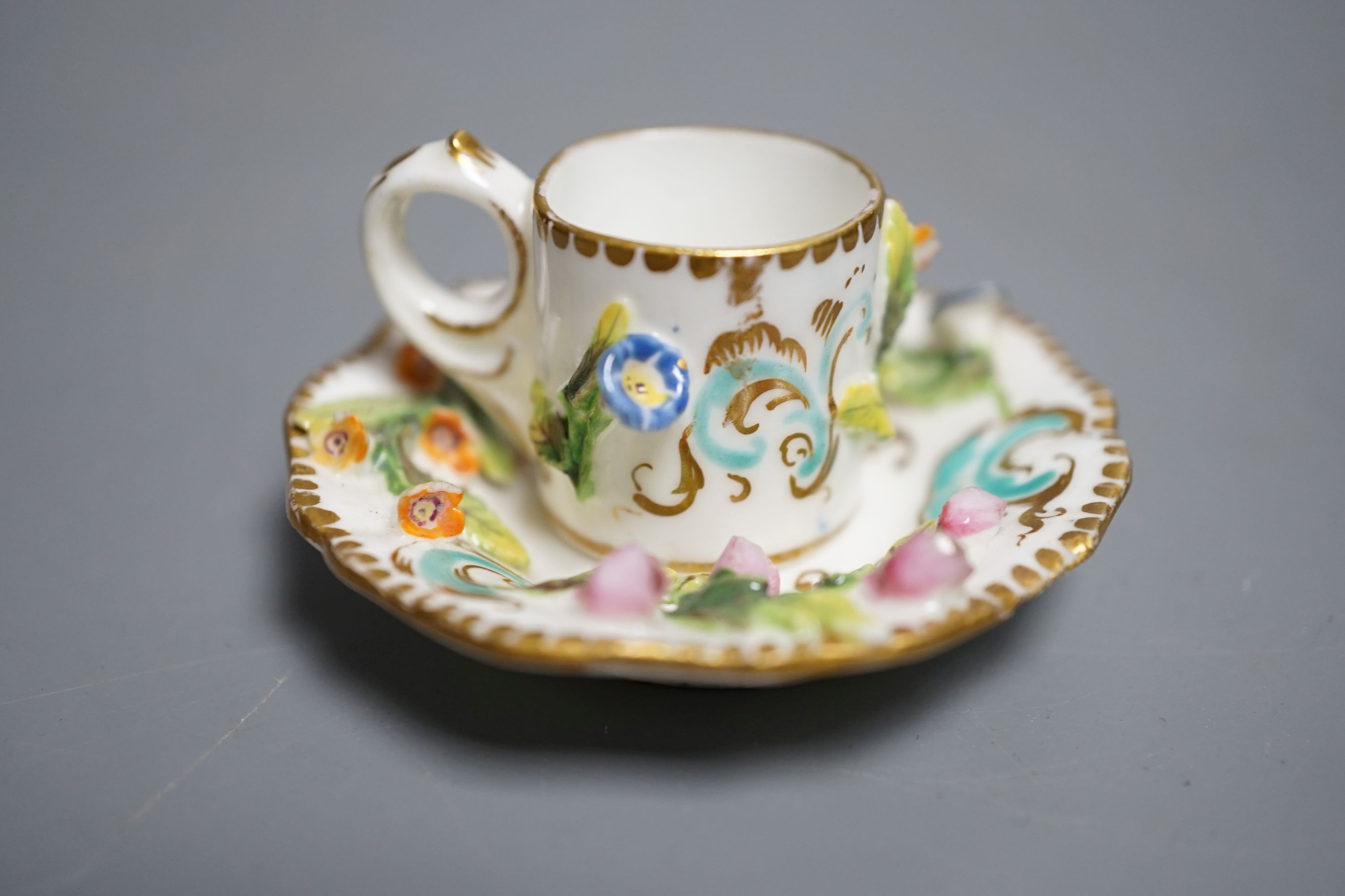 A Coalbrookdale miniature flower encrusted cup and saucer, c.1820. Provenance - Mona Sattin collection of miniature cups and saucers, collection no. 194.